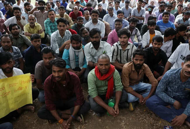 Factory workers hold a protest demanding wage hikes from their company