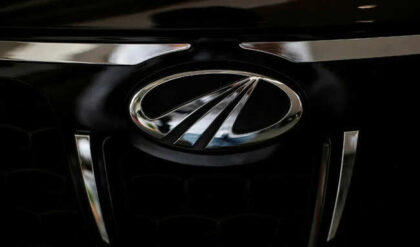 The logo of Mahindra and Mahindra is seen on a car at a showroom in Mumbai