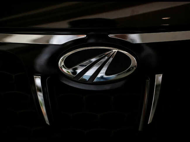 The logo of Mahindra and Mahindra is seen on a car at a showroom in Mumbai