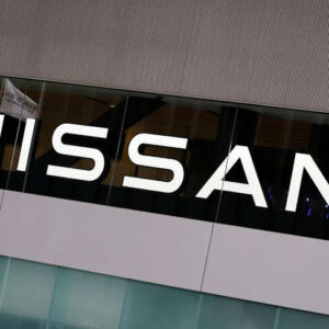 Japan’s national flag is reflected on a logo of  Nissan Motor Co. at its headquarters in Yokohama