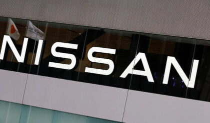 Japan’s national flag is reflected on a logo of  Nissan Motor Co. at its headquarters in Yokohama