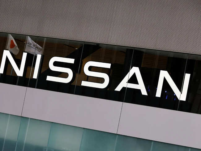 Japan’s national flag is reflected on a logo of  Nissan Motor Co. at its headquarters in Yokohama